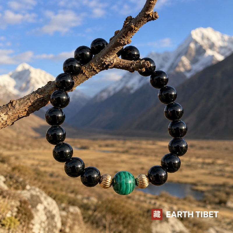 Tourmaline malachite bracelet hanging on a branch above a Himalayan valley