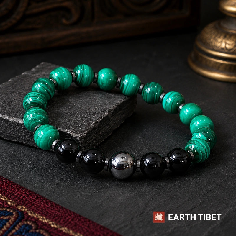Full circle of the malachite bracelet showing the single mirror-grey hematite centre bead