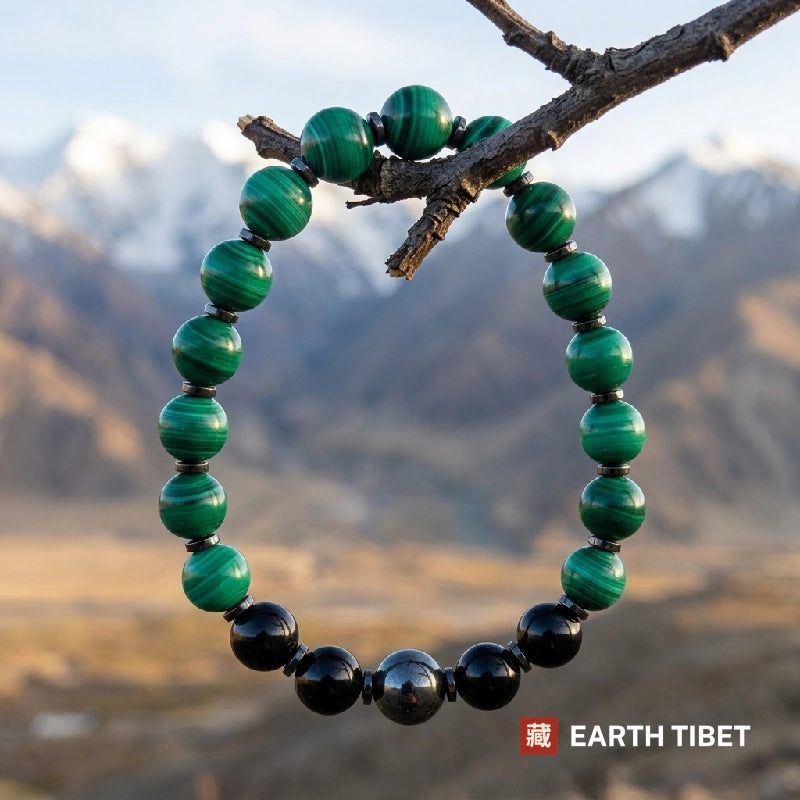 Close up of malachite banding and the polished black tourmaline beads
