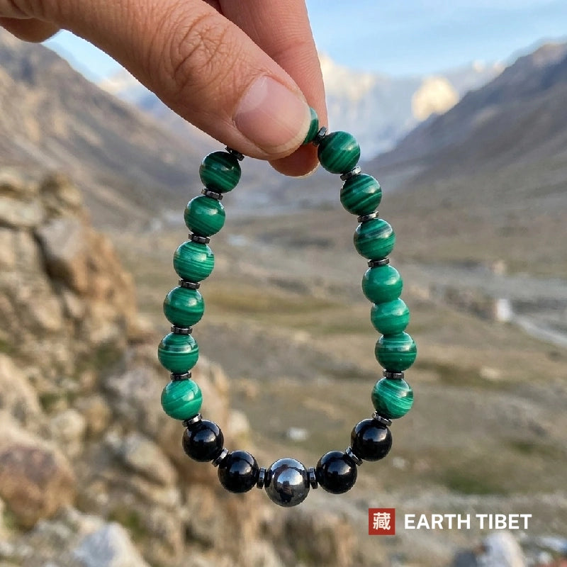 Malachite, tourmaline and hematite stretch bracelet against carved wood