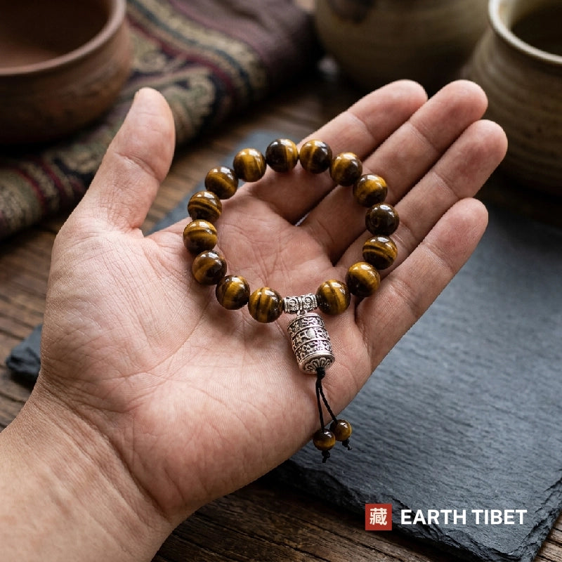 Tiger eye prayer barrel bracelet resting in an open hand