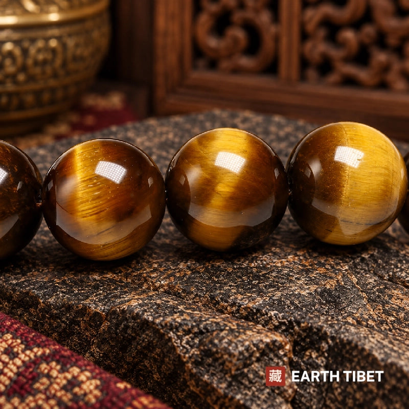 Macro of four polished tiger eye beads showing the chatoyant stripe