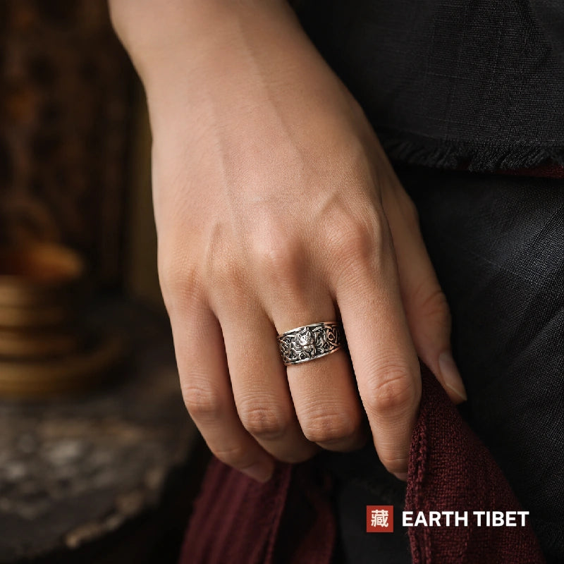Nine-tailed fox ring worn on a hand against dark linen