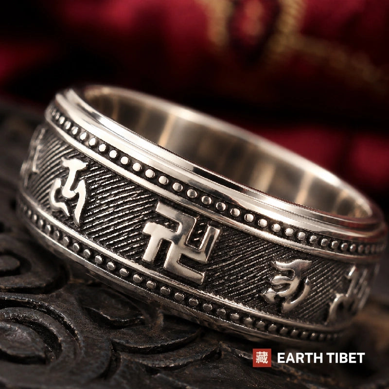 Close up of the spinner ring showing the raised mantra, the manji and the seam of the rotating band