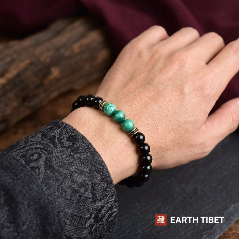 Man wearing the black onyx and malachite beaded bracelet on his wrist