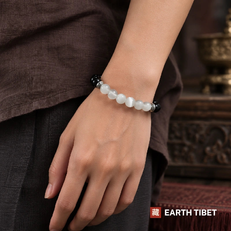 Silky light running down the selenite beads of the onyx selenite balance bracelet