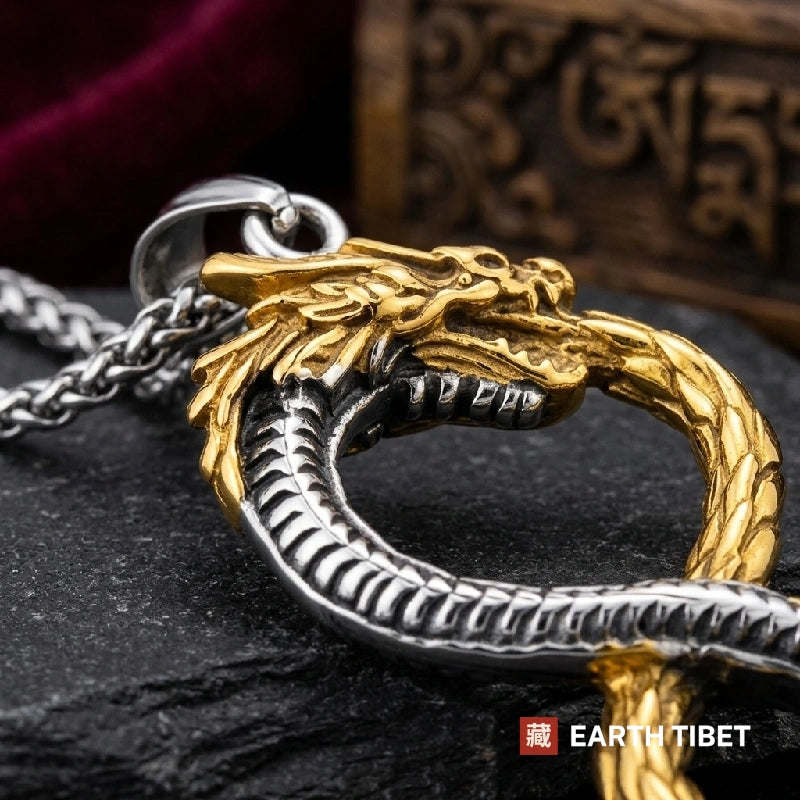 Close up of the gold dragon head and antiqued steel belly plates on the ouroboros dragon pendant