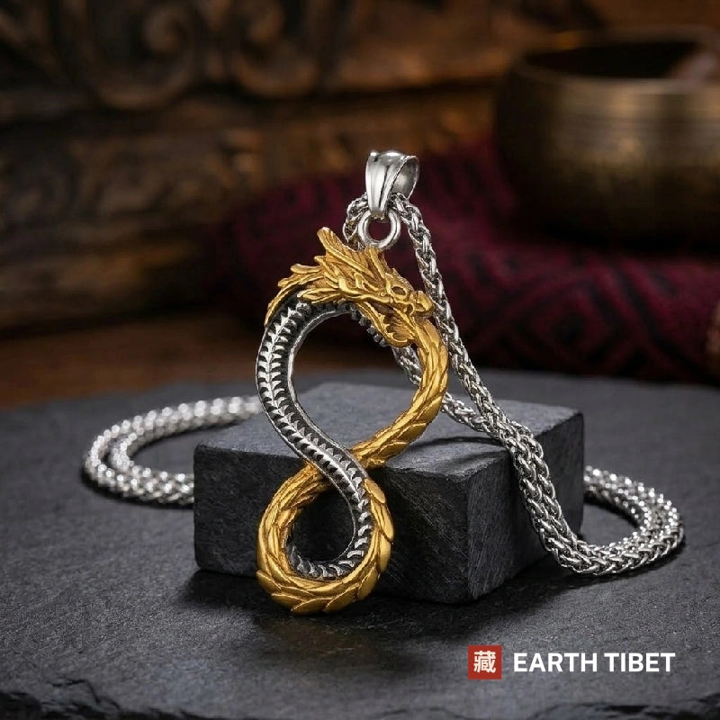 Two-tone steel and gold coiled dragon pendant, showing where the body crosses over itself