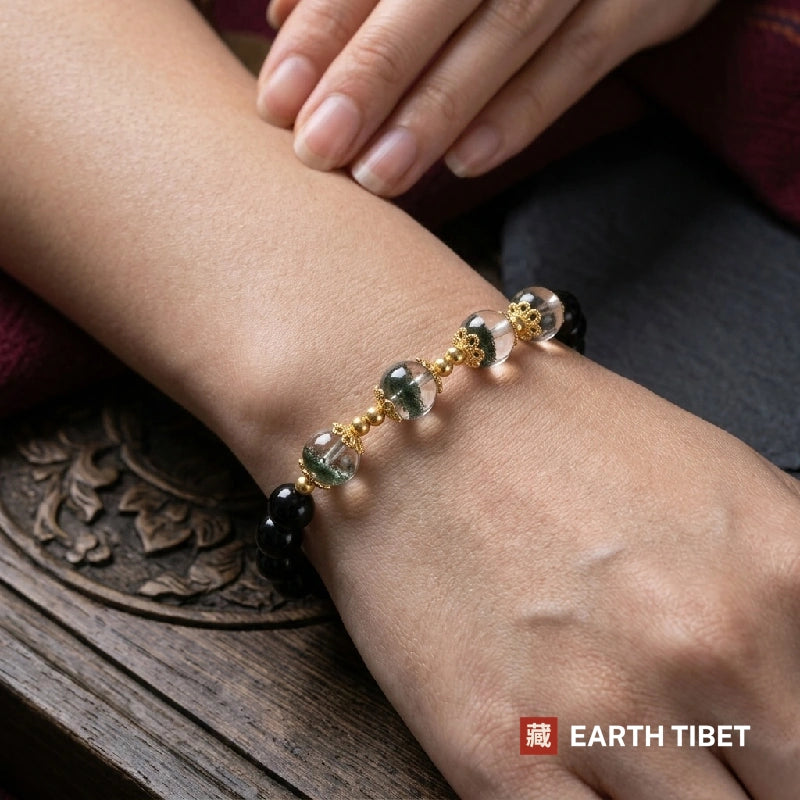 Woman wearing the green phantom quartz and black obsidian bracelet on her wrist