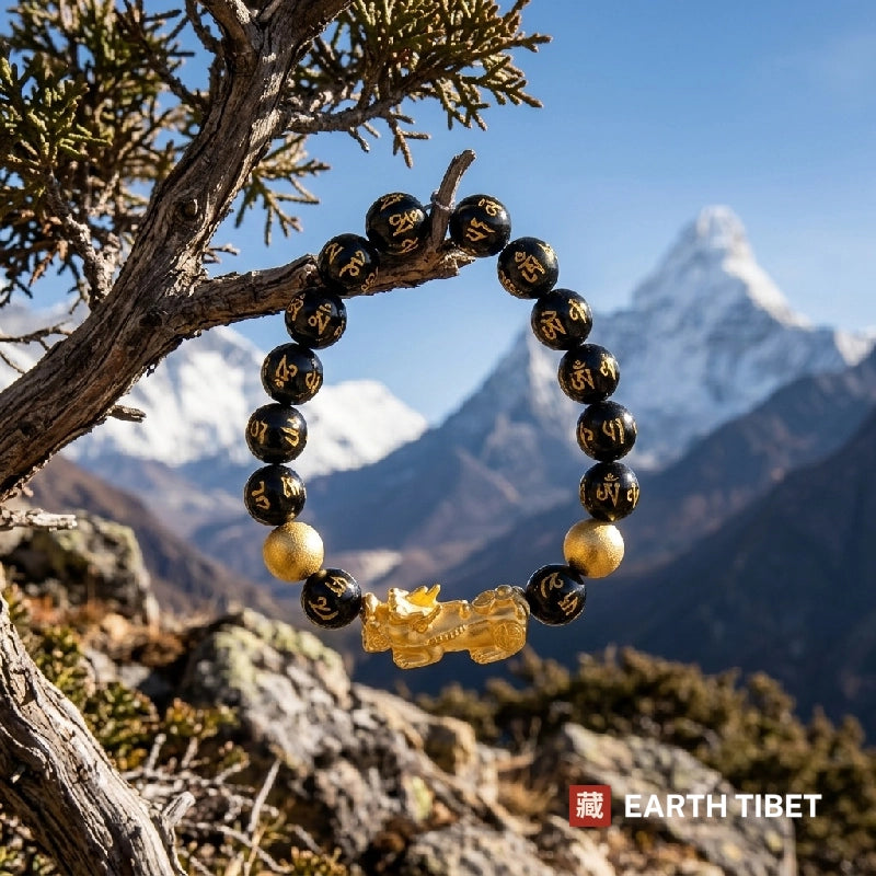 Pixiu mantra bracelet hanging from a branch with Himalayan peaks behind