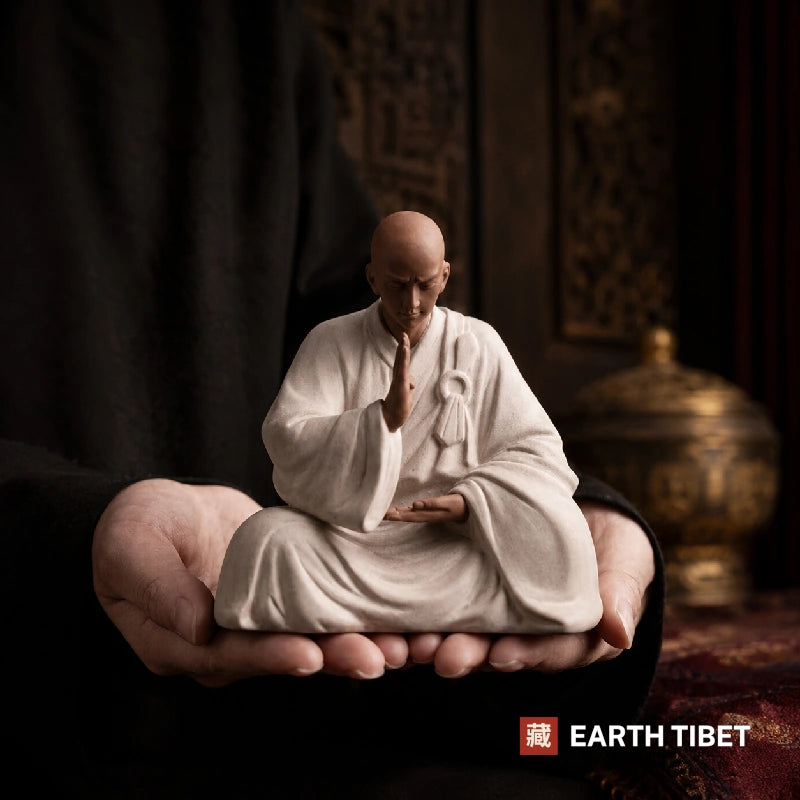 Close up of the speckled purple clay finish on the monk statue robe