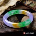 Tricolour bangle in lavender, green and yellow on a carved wooden box