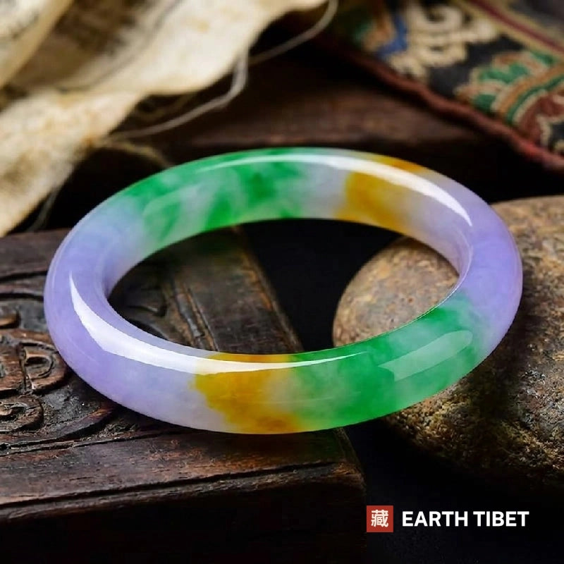 Tricolour bangle in lavender, green and yellow on a carved wooden box