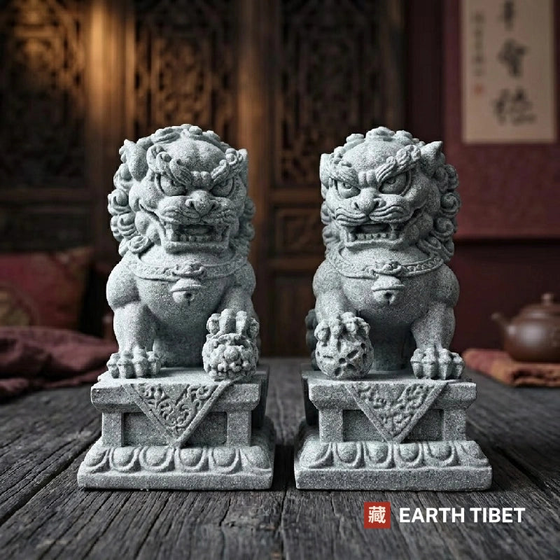 Pair of Chinese guardian lion statues in sandstone on carved plinths, male and female