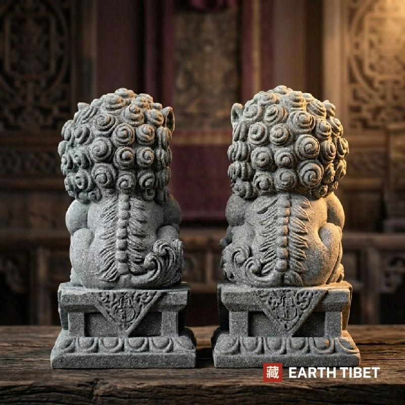 Sandstone guardian lion statues shown on their lotus-petal plinths
