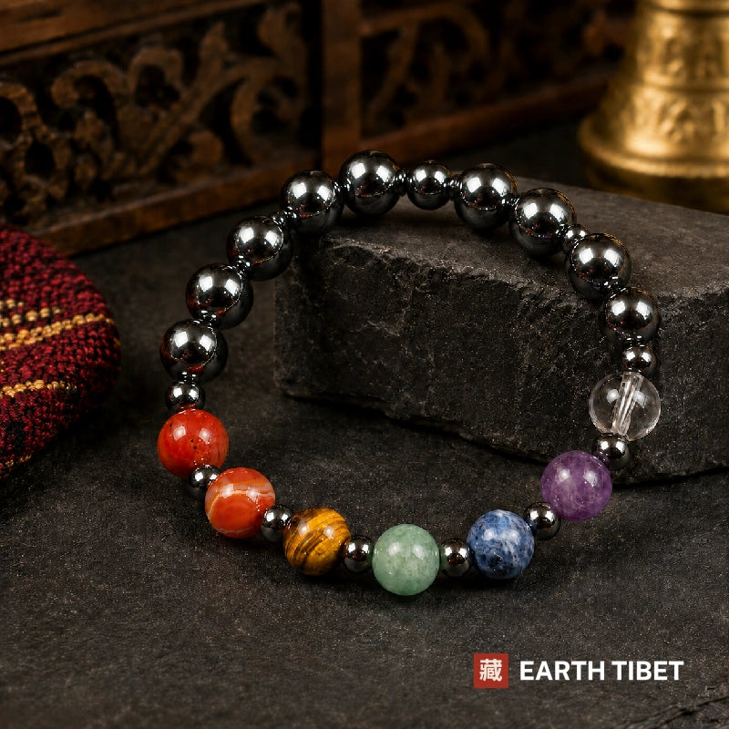 Seven chakra bracelet, coloured stones across the front on a loop of mirror-black hematite