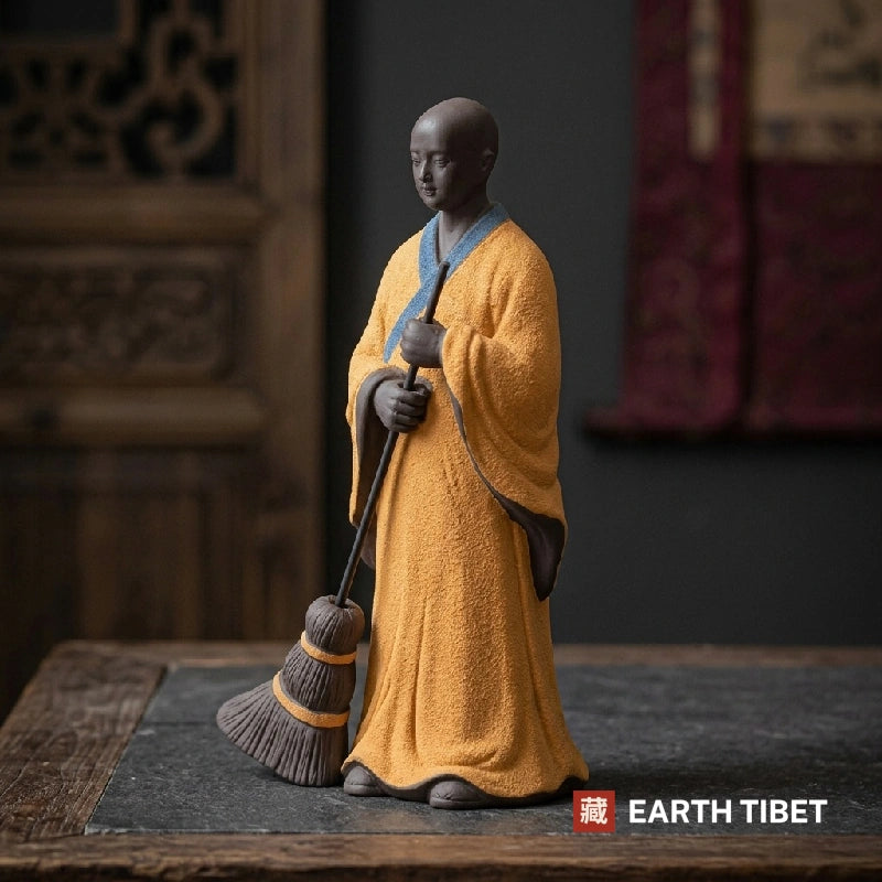 Three quarter view of the sweeping monk showing the coarse grain of the unglazed clay robe
