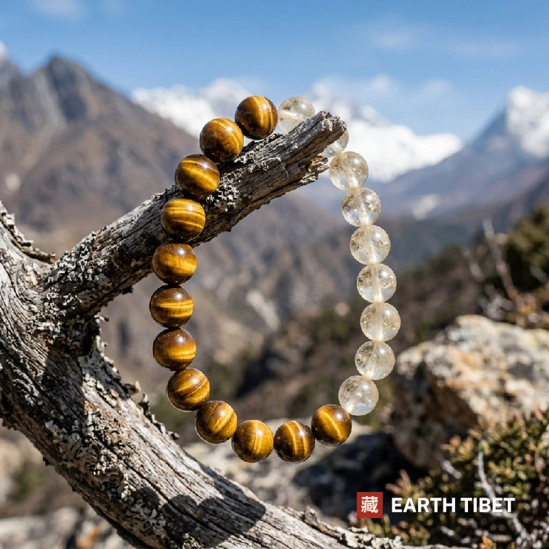Citrine and tiger eye bracelet resting on a branch with Himalayan peaks behind