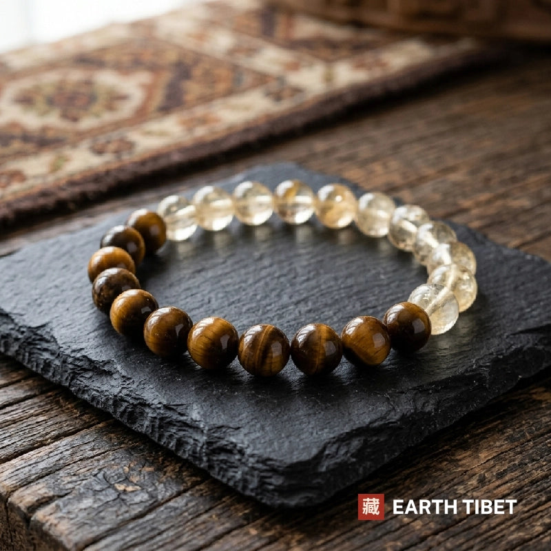 Citrine and tiger eye beads photographed on a dark slate tile