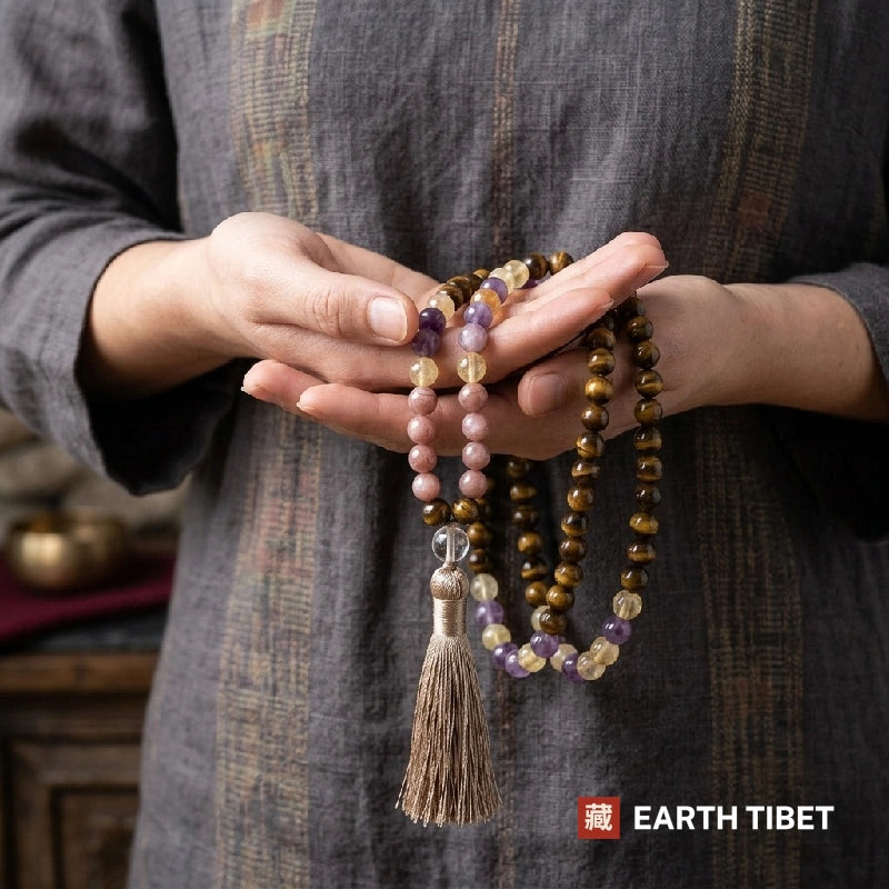 Sunstone and tiger eye mala held in two open hands