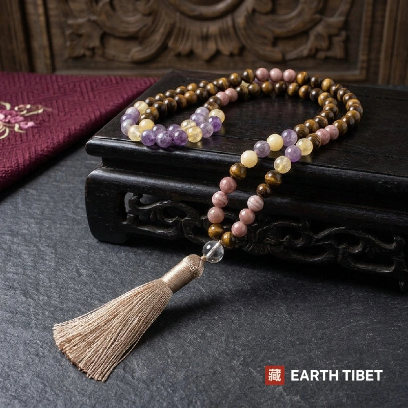 108 bead mala in tiger eye, citrine, amethyst and pink stone on a carved wooden stand
