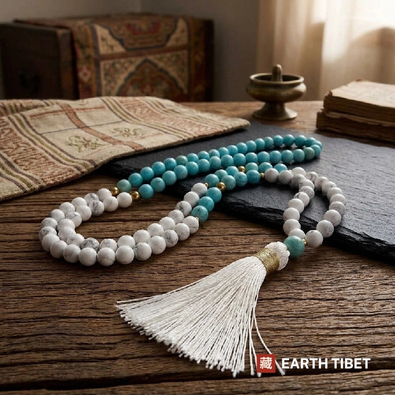 Full length of the mala laid out on slate in low window light