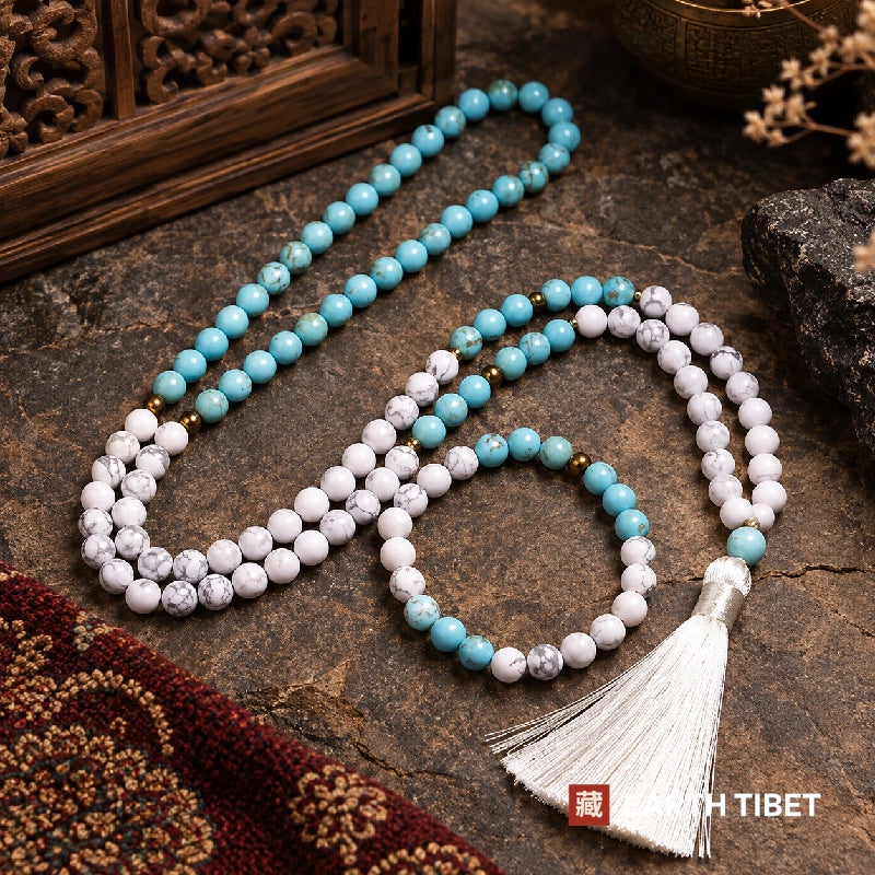 Turquoise howlite mala with its matching bracelet on a stone slab
