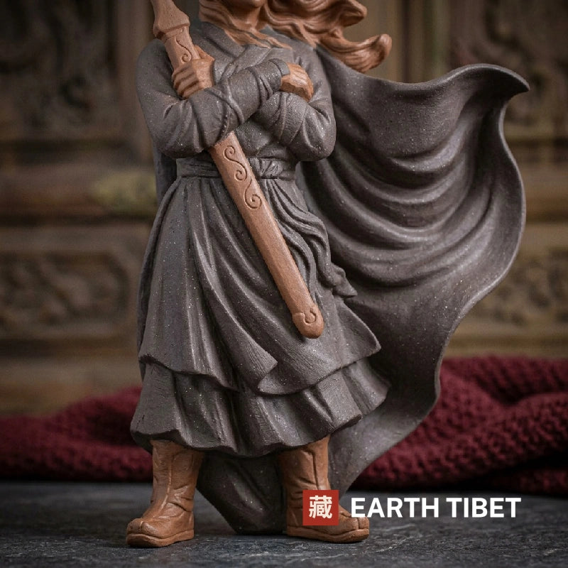 Close view of the swordsman's grey robe, cloak and terracotta sword and boots