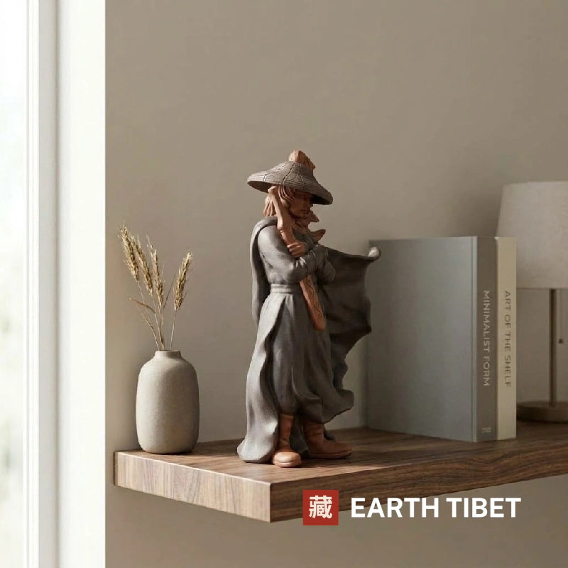 Wandering swordsman statue standing on a shelf beside a vase and books