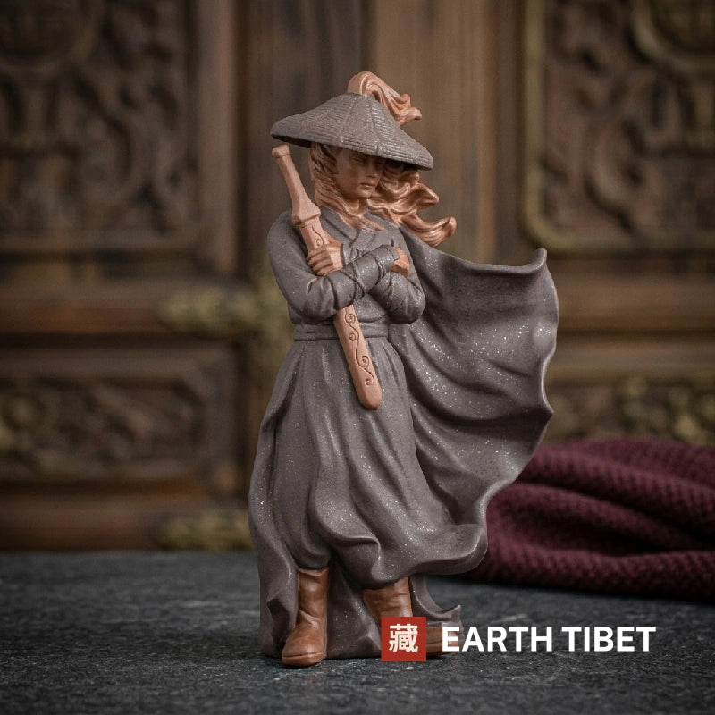 Front view of the swordsman holding the sword upright in both hands