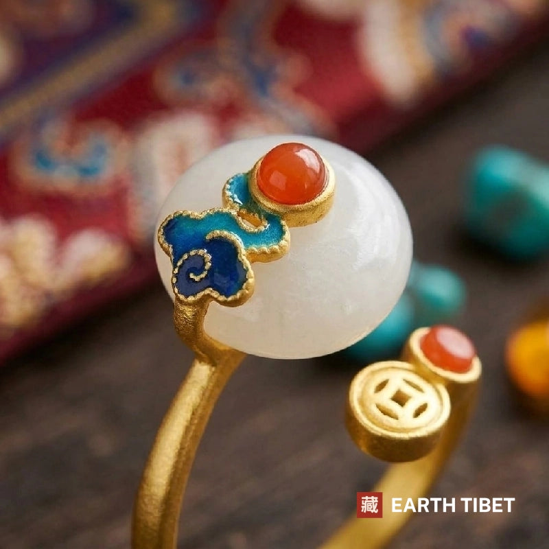 Close view of the blue enamel cloud, red cabochon and the square-holed coin terminal
