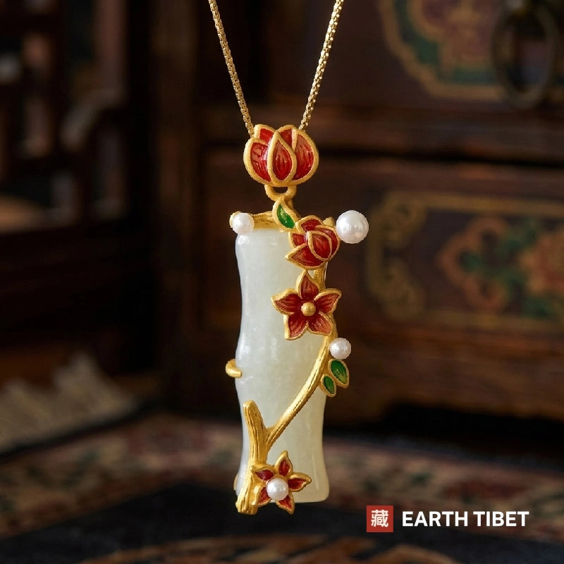 White chalcedony bamboo pendant with red enamel plum blossoms on a gold-toned chain