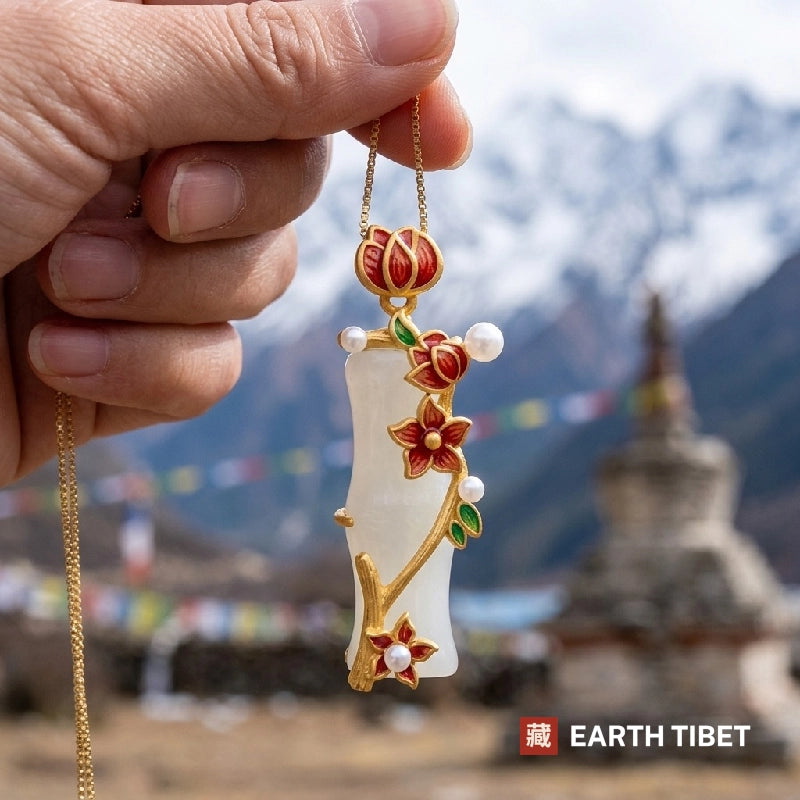 Bamboo blossom necklace held up in front of a stupa and prayer flags