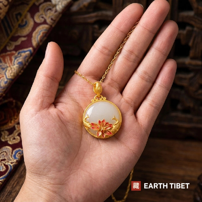 White chalcedony koi and lotus necklace lying in an open hand