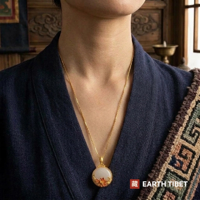 Koi lotus necklace worn at the collar of a dark indigo jacket