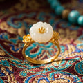 Plum blossom ring standing upright showing the branch-shaped gold-toned band