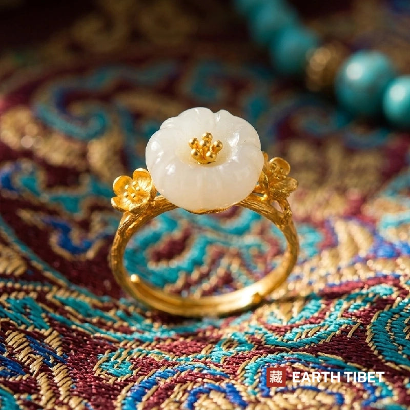 Plum blossom ring standing upright showing the branch-shaped gold-toned band