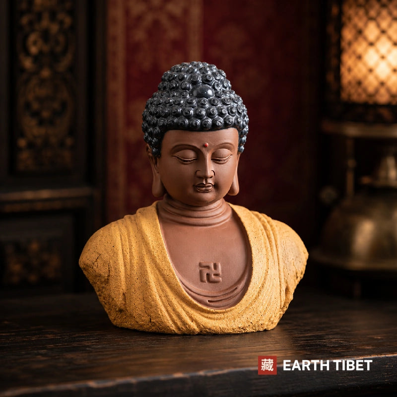 Ceramic Buddha bust with snail-shell curls, shown in a dark interior