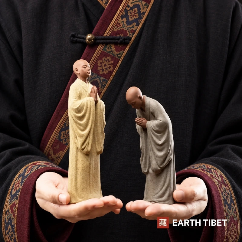 Both novice monk statues held in two open hands to show their size